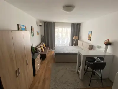 a small bedroom with a bed and a desk at Royal Palm Studio with Seaview in Sveti Vlas