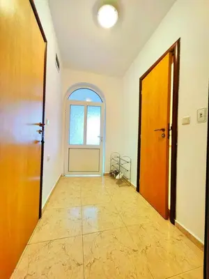 an empty hallway with two doors and a window at Kambani Arnel Apartment , Marina in Sveti Vlas