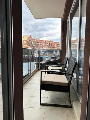 a balcony with a table and chairs on a building at Admiral Plaza Apartment , Large swimming pool , 5 min walking to the beach in Sunny Beach
