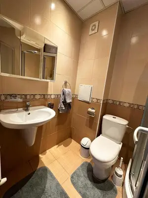 a bathroom with a white toilet and a sink at Admiral Plaza Apartment , Large swimming pool , 5 min walking to the beach in Sunny Beach