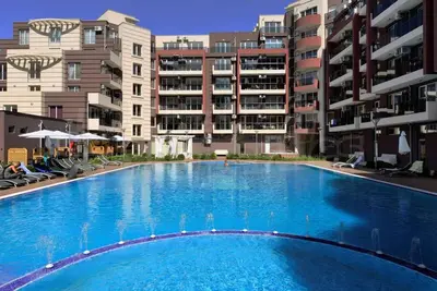 a large swimming pool in front of some apartment buildings at Admiral Plaza Apartment , Large swimming pool , 5 min walking to the beach in Sunny Beach