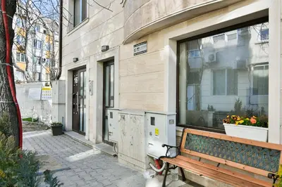 a bench sitting in front of a building with a window at Varna beach flat 1 in Varna City