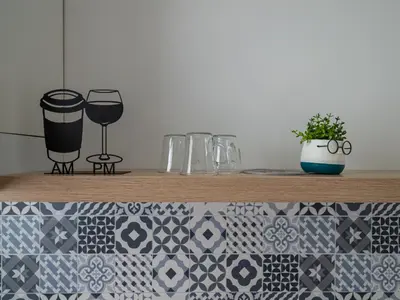 a wooden shelf with glasses and a potted plant at Buongiorno! Premium in Sveti Vlas