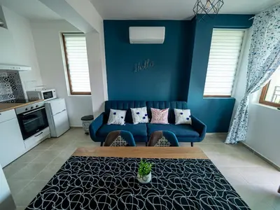a blue living room with a couch and a table at Buongiorno! Premium in Sveti Vlas