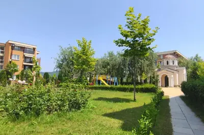 a yard with a playground and a house at Apartment Ferienunterkunft Strandnähe mit Pools in Sunny Beach