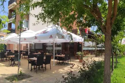a restaurant with tables and chairs under umbrellas at Apartment Ferienunterkunft Strandnähe mit Pools in Sunny Beach