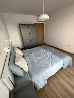 a bedroom with a large bed in a room at Cosy apartments with sea view in complex PANORAMA in Chernomorets