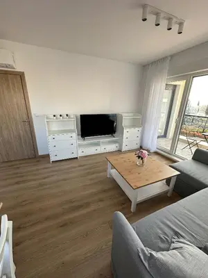a living room with a tv and a coffee table at Cosy apartments with sea view in complex PANORAMA in Chernomorets