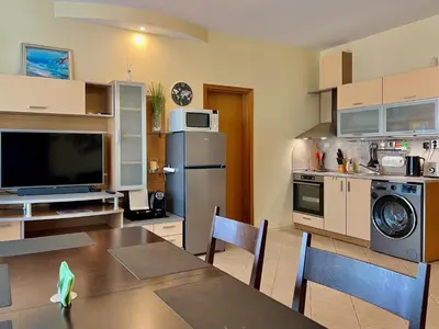 a kitchen with a table and a dining room at Premium Apartment Midia Beach in Sunny Beach