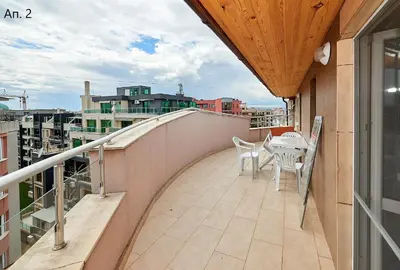 a balcony with a table and chairs on a building at Апартаменти Боряна in Pomorie