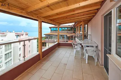 a balcony with a table and chairs on it at Апартаменти Боряна in Pomorie
