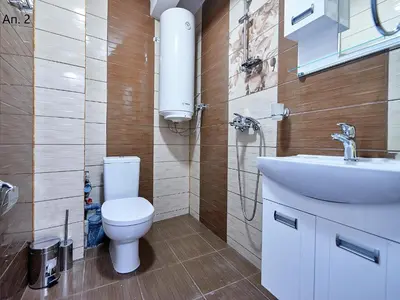 a bathroom with a toilet and a sink at Апартаменти Боряна in Pomorie
