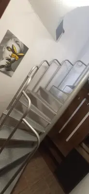 a metal bunk bed in a room with a picture at Апартамент с две спални. in Varna City