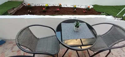 a patio with two chairs and a table with a potted plant at Апартамент с две спални. in Varna City