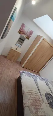 a bedroom with a bed in a room with a ceiling at Апартамент с две спални. in Varna City