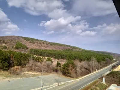 a view of a road with a mountain in the background at Apartament Panorama - BastetBS in Sveti Vlas