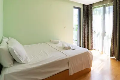 a bedroom with a bed with two towels on it at Central flat with Monster living room in Varna City