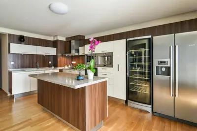 a kitchen with white cabinets and stainless steel appliances at Central flat with Monster living room in Varna City