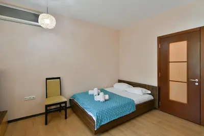 a bedroom with a bed with a chair and candles on it at Budget central next to sea garden and beach in Varna City