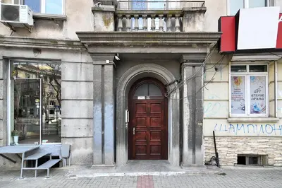 a wooden door on the side of a building at Budget central next to sea garden and beach in Varna City