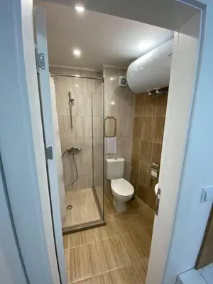 a bathroom with a shower and a toilet in it at Студио Симона 4 - първа линия море in Lozenets