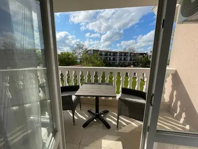 a table and chairs on a balcony with a view at Студио Симона 4 - първа линия море in Lozenets