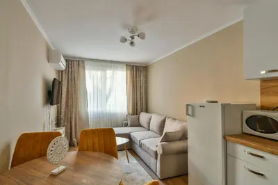 a kitchen and a living room with a couch and a table at Top location flats in Varna in Varna City