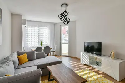 a living room with a couch and a tv at Top location flats in Varna in Varna City