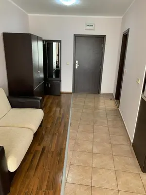 a living room with a couch and wooden floors at Студио Нели- Созополистайл Клуб in Sozopol