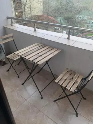 a bench and two chairs at a counter with a window at Студио Нели- Созополистайл Клуб in Sozopol
