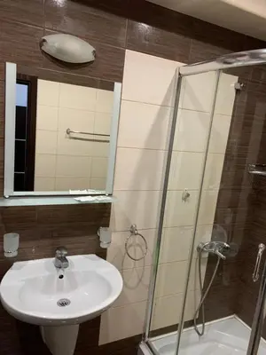a bathroom with a sink and a shower at Студио Нели- Созополистайл Клуб in Sozopol
