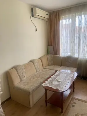 a living room with a couch and a coffee table at Pomorie Apartment in Pomorie