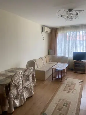 a living room with a couch and a table at Pomorie Apartment in Pomorie
