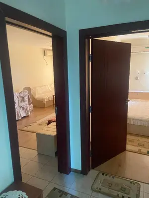 a room with a door and a living room at Pomorie Apartment in Pomorie
