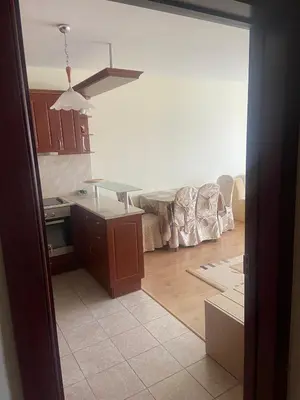 a kitchen with a counter and a table in it at Pomorie Apartment in Pomorie