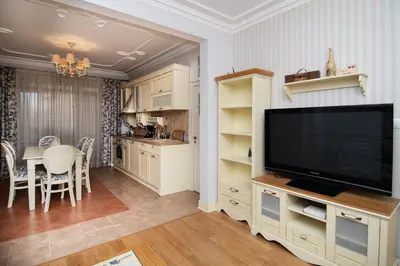 a living room with a television and a dining room at Cozy central flat in Varna Downtown in Varna City