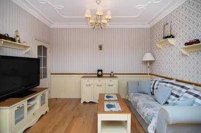 a living room with a couch and a tv at Cozy central flat in Varna Downtown in Varna City
