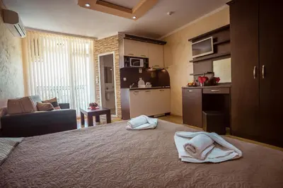 a bedroom with a bed with towels on it at BIATO APARTMENTS - ALL INCLUSIVE in Sunny Beach