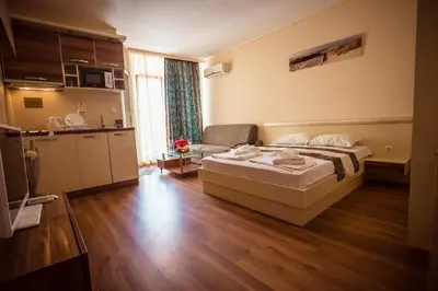 a hotel room with a bed and a kitchen at BIATO APARTMENTS - ALL INCLUSIVE in Sunny Beach