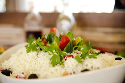 a bowl of rice with vegetables on top of it at BIATO APARTMENTS - ALL INCLUSIVE in Sunny Beach