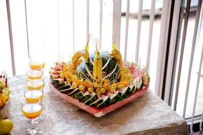 a fruit centerpiece on a table with glasses of orange juice at BIATO APARTMENTS - ALL INCLUSIVE in Sunny Beach