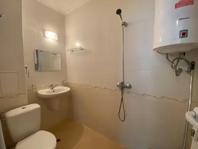 a bathroom with a toilet and a sink at VIOLET GARDEN 2 Veranda Apartment in Sunny Beach