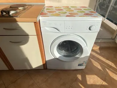 a washing machine with a bed on top of it at BALKAN BREEZE 15 Apartment in Sunny Beach