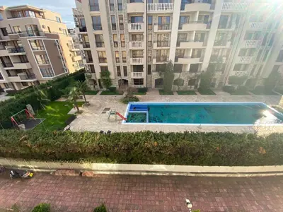 a swimming pool in front of a large building at BALKAN BREEZE 15 Apartment in Sunny Beach