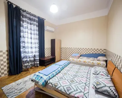 a bedroom with two beds and a window at Summer Square - 2 bedrooms Retro Flat with great location, 1st fl in Burgas City