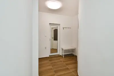 a hallway with a mirror in a white room at Central 3BR with parking nearby Opera in Varna City
