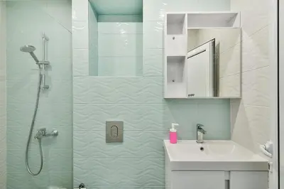 a white bathroom with a shower and a sink at Central 3BR with parking nearby Opera in Varna City