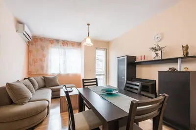 a living room with a table and a couch at Sea&Park Apartment in Varna City