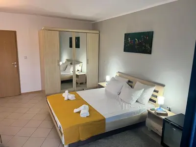 a bedroom with a large bed with towels on it at Large apartment in Sunny Beach in Sunny Beach