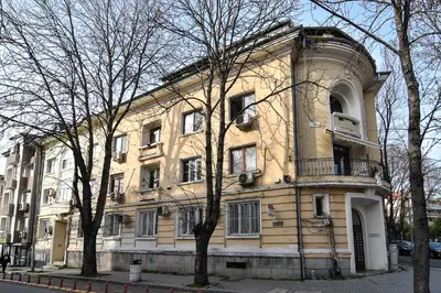 a large yellow building on the side of a street at Budget studio in Varna center unde roof in Varna City